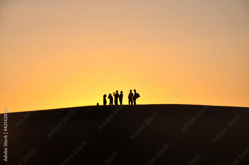 Silhouette of travelers at sunset
