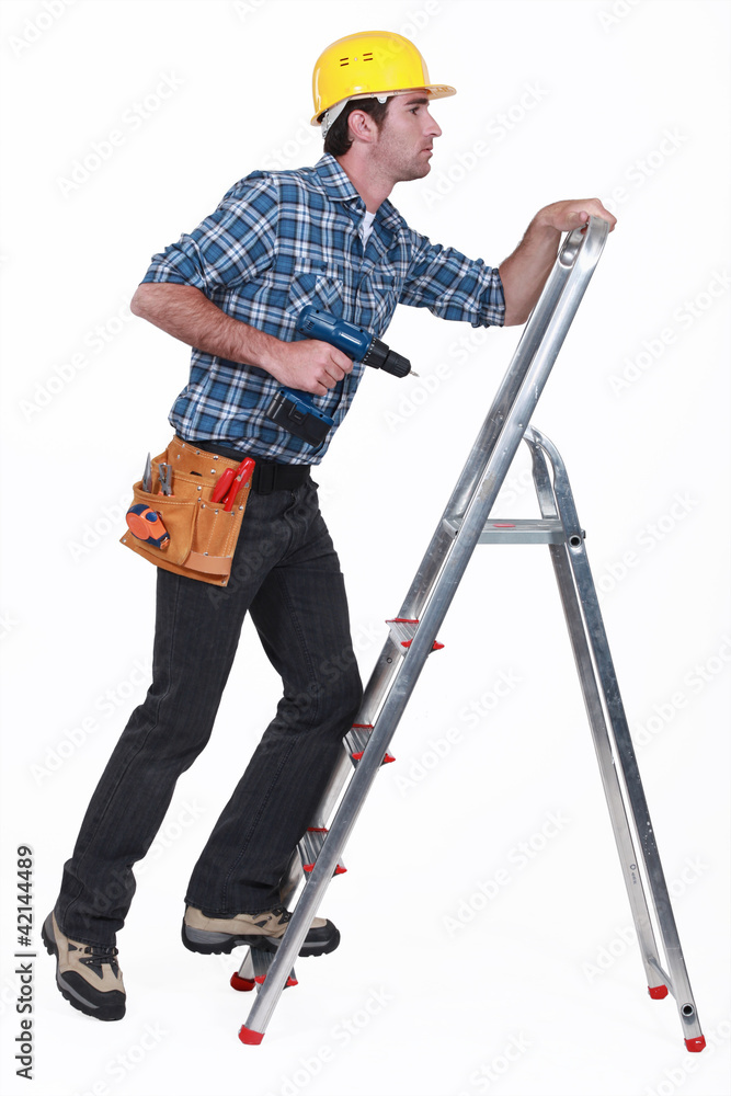 A handyman climbing a ladder. A handyman climbing a ladder.