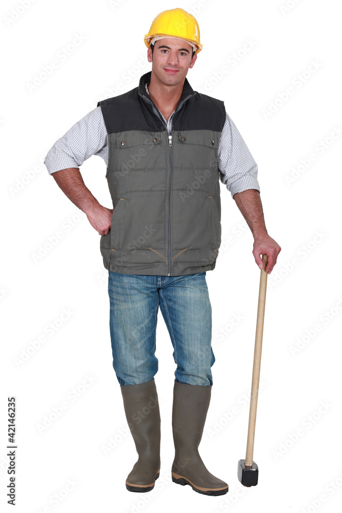 Construction worker posing with sledge-hammer Construction worker posing with sledge-hammer