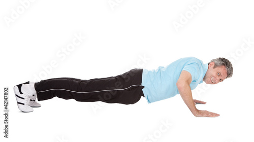 Active mature man doing pushups