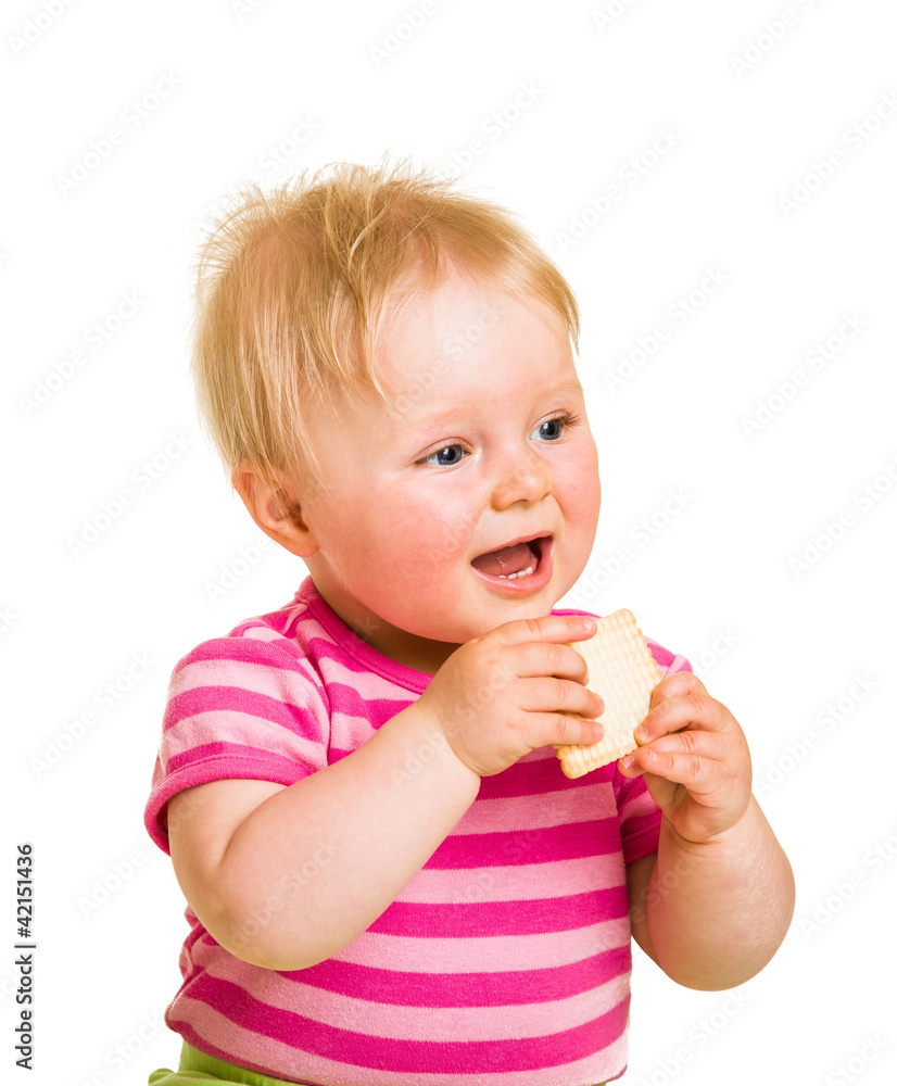 Infant baby learning to eat a biscuit Infant baby learning to eat a biscuit