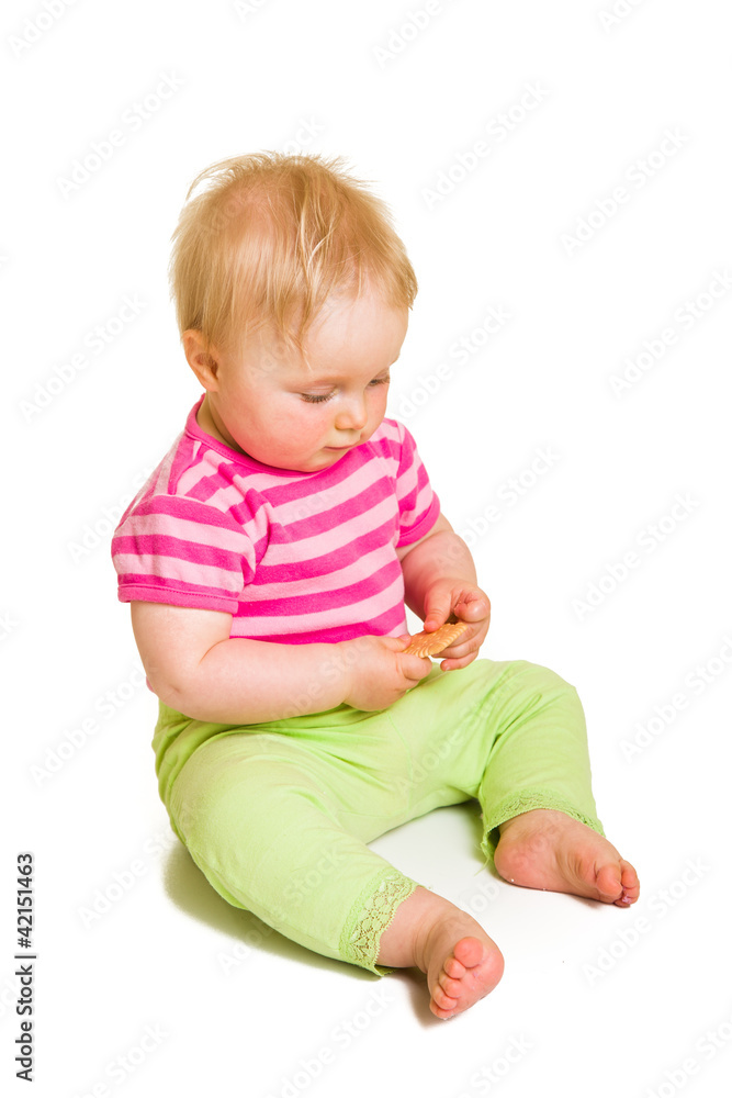 Infant baby learning to eat a biscuit Infant baby learning to eat a biscuit