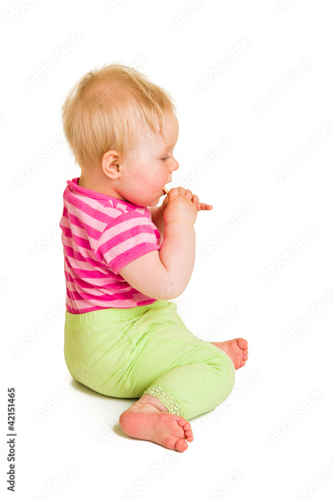 Infant baby learning to eat a biscuit Infant baby learning to eat a biscuit