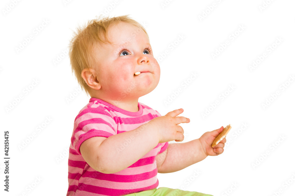 Infant baby learning to eat a biscuit