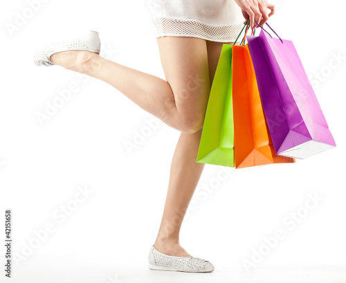 Girl holding multicolored shopping paper bags
