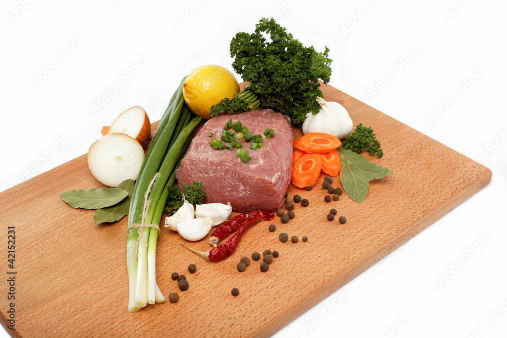 raw meat, vegetables and spices isolated on a wooden table.