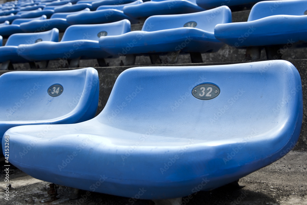 Fototapeta premium blue ordered rubber seats in a sports track field