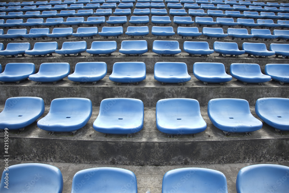 Fototapeta premium blue ordered rubber seats in a sports track field