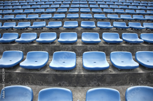 blue ordered rubber seats in a sports track field © humannet