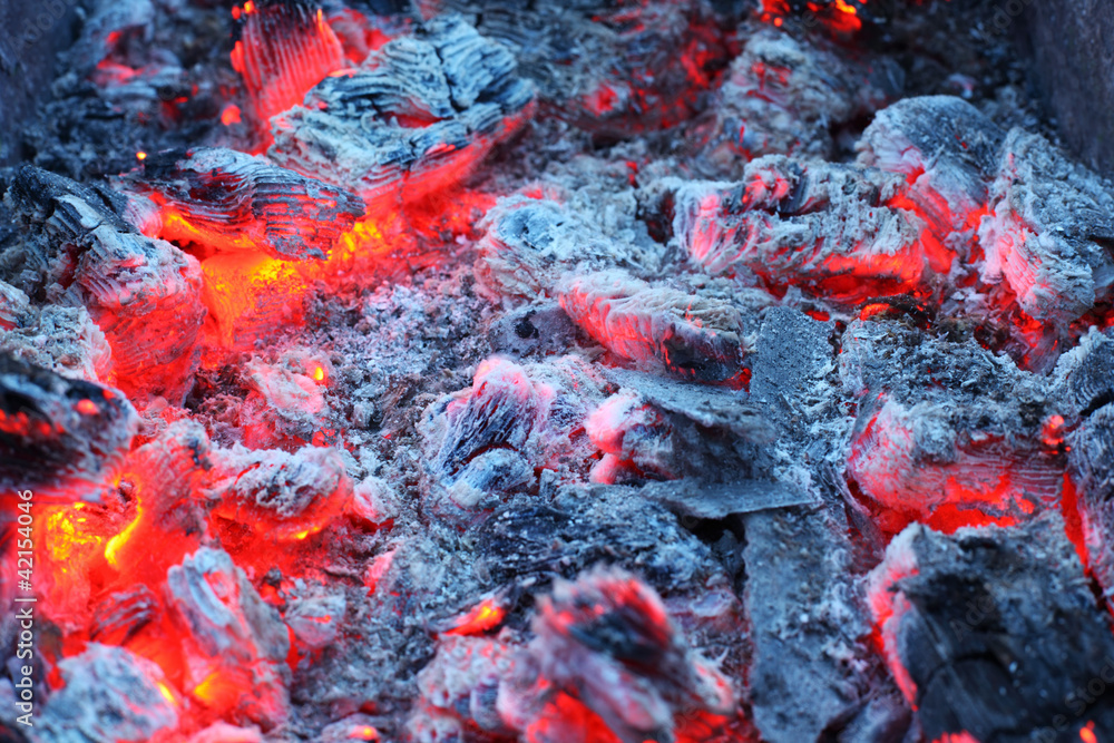 Closeup of warm glowing embers in fireplace; white and gray ash Closeup of warm glowing embers in fireplace; white and gray ash