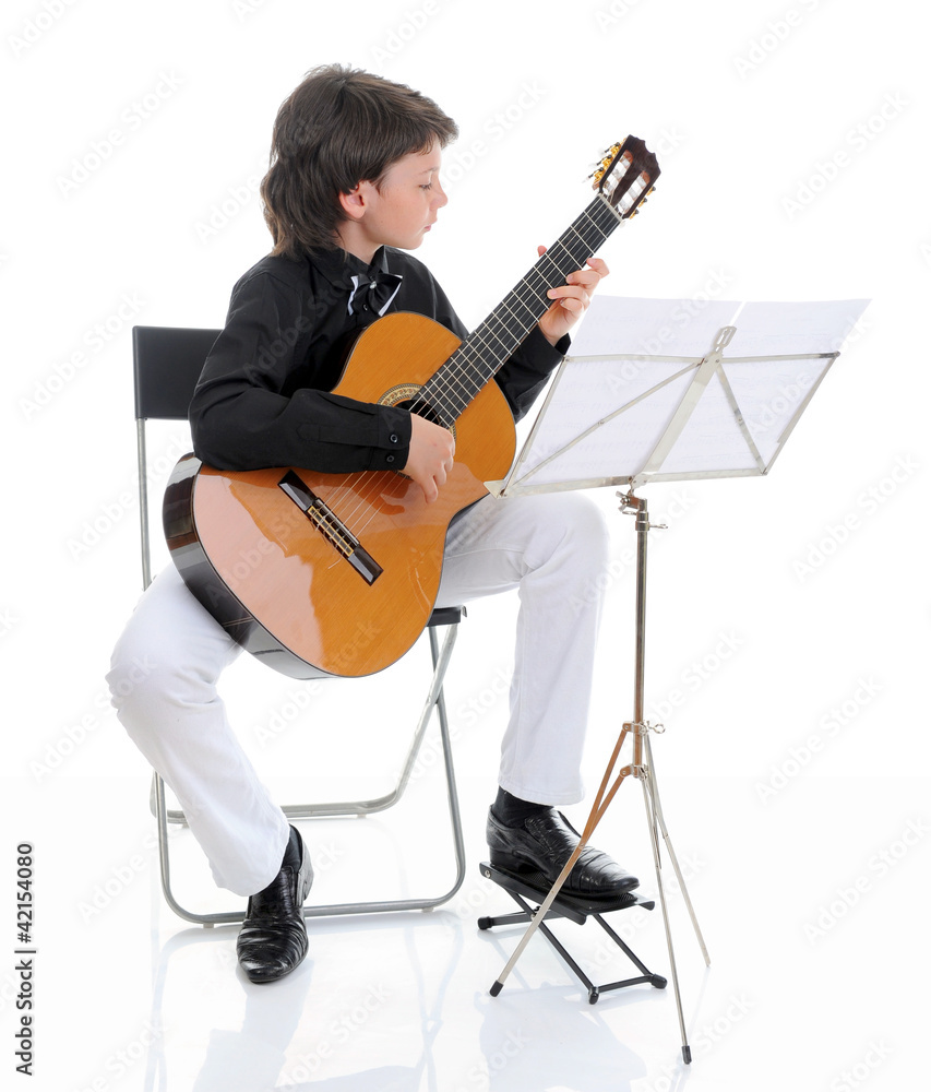 Fototapeta premium Little boy musician playing guitar