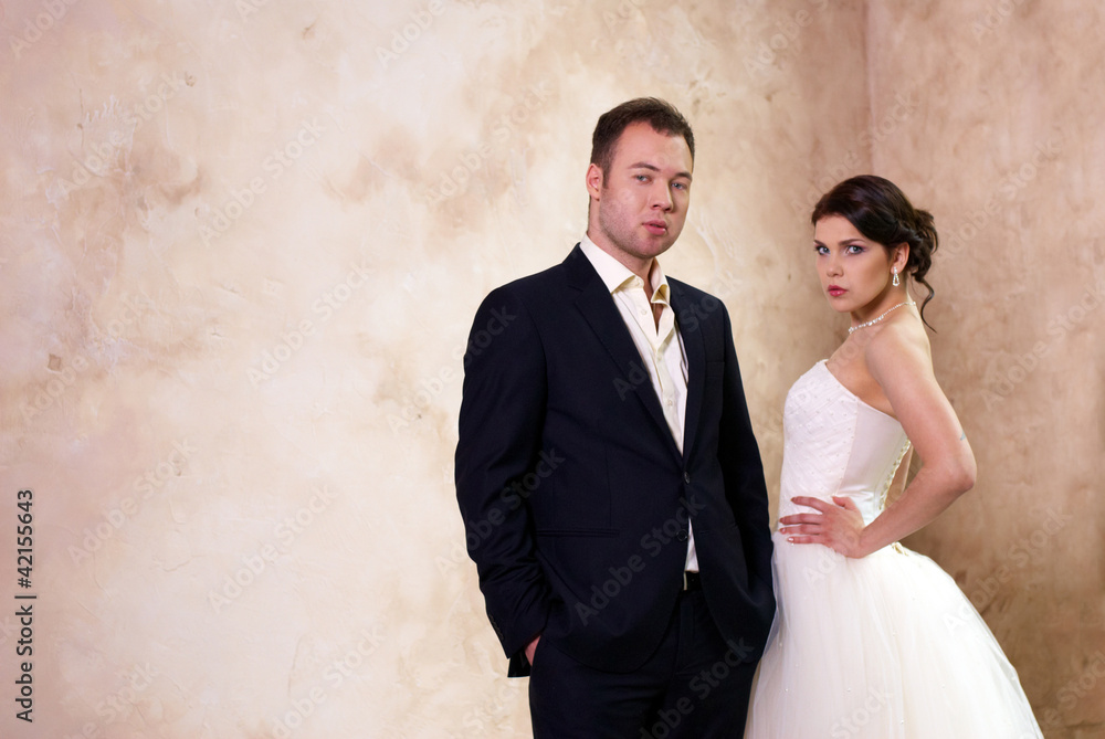 bride and groom standing in empty room bride and groom standing in empty room