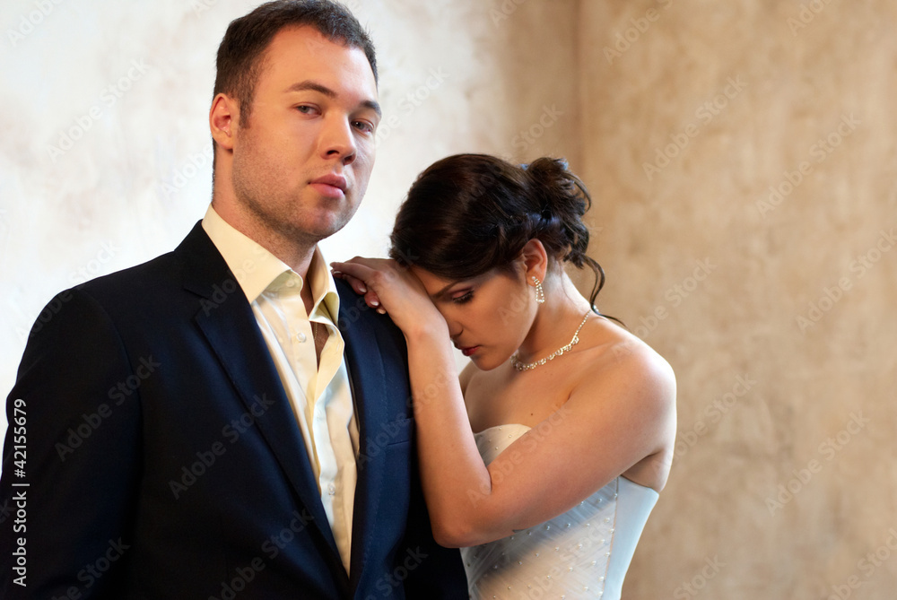 bride and groom standing in empty room bride and groom standing in empty room