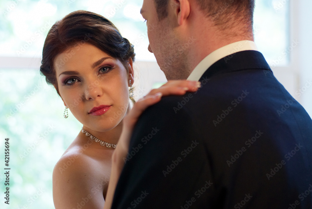 bride and groom hugging in empty room bride and groom hugging in empty room