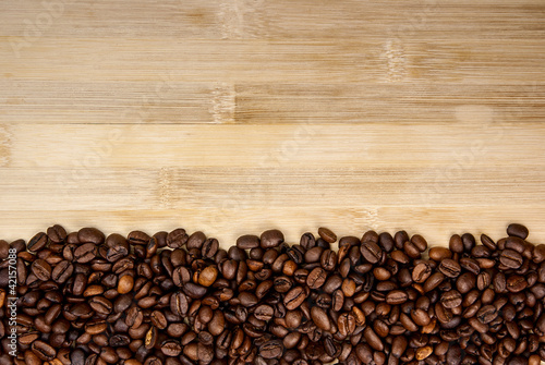 A pile of coffee beans forming a simple stripe frame