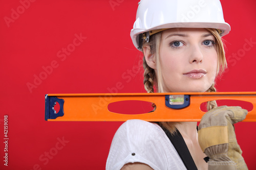 Obraz na plátně craftswoman holding ruler against red background