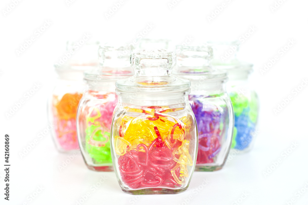 Colorful plastic hearts in glass bottles. Colorful plastic hearts in glass bottles.
