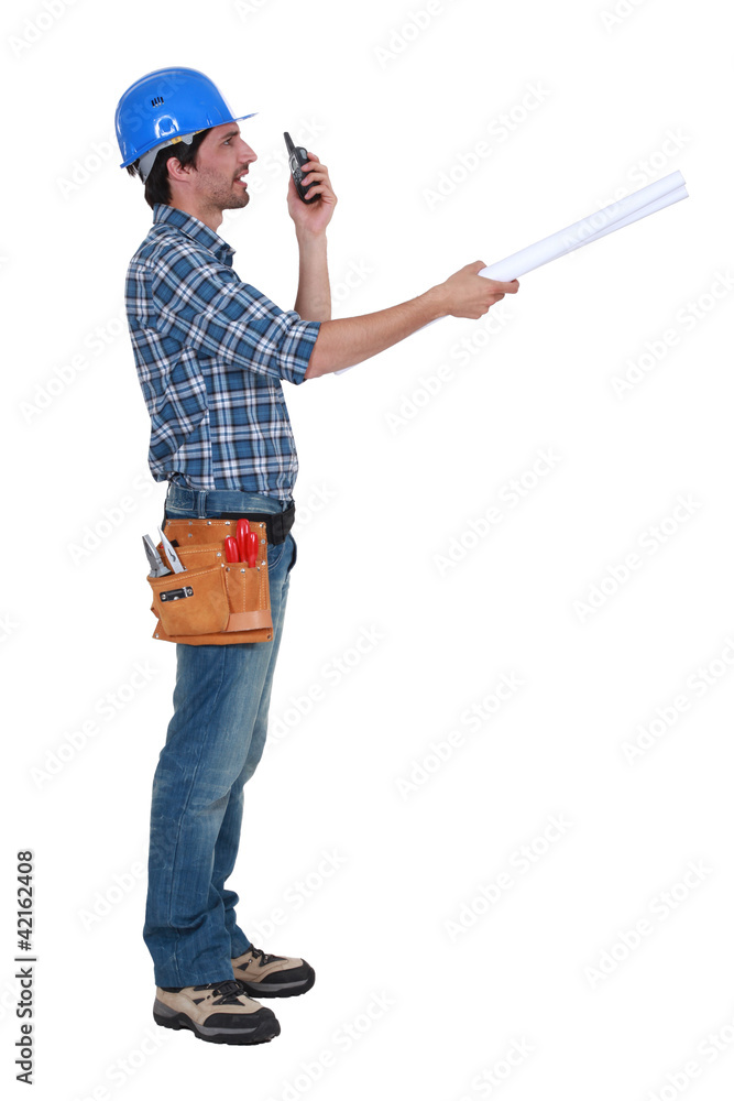 Tradesman trying to communicate with his colleague Tradesman trying to communicate with his colleague