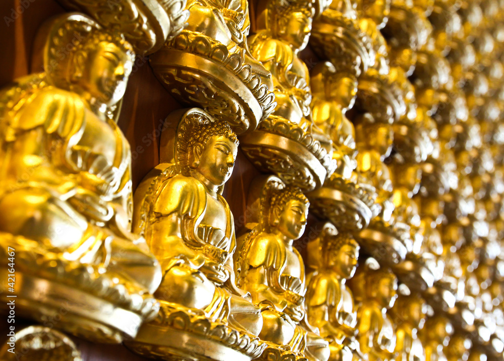 Many small Buddha statue on the wall at chinese temple, Thailand Many small Buddha statue on the wall at chinese temple, Thailand