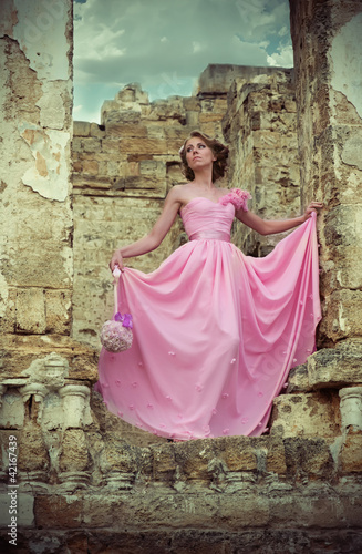 Woman in pink wedding dress in ruins © rodjulian