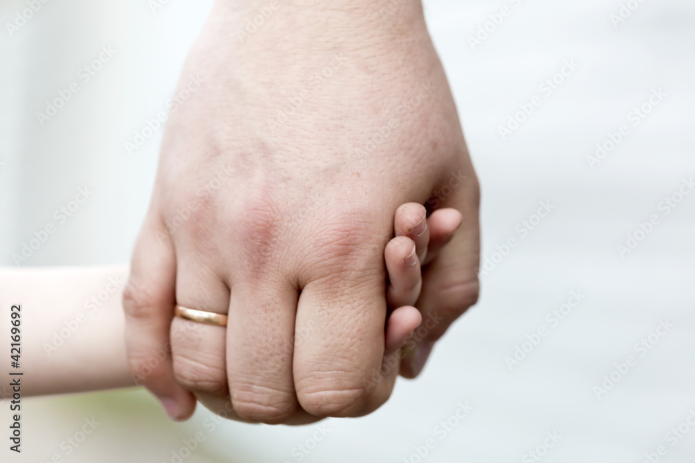 Children's hand in a man's hand Children's hand in a man's hand