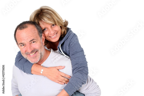 Senior man holding wife on his back