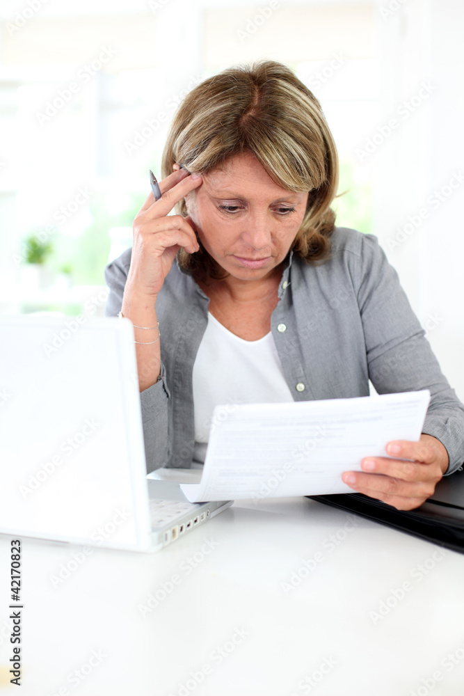 Senior woman having problems understanding official documents Senior woman having problems understanding official documents