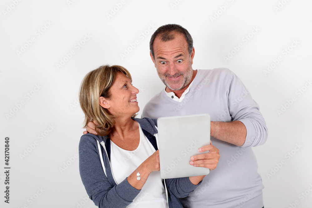 Senior couple having fun with electronic tablet Senior couple having fun with electronic tablet