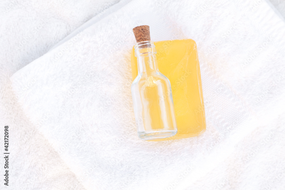 Obraz premium soap and bottles on a white towel