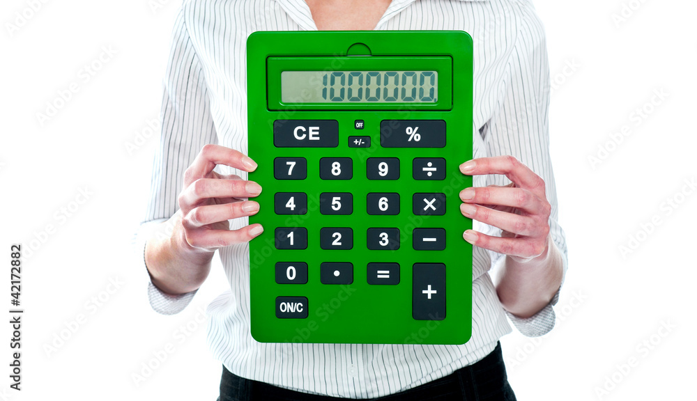 Focus on green calculator. Woman holding Focus on green calculator. Woman holding