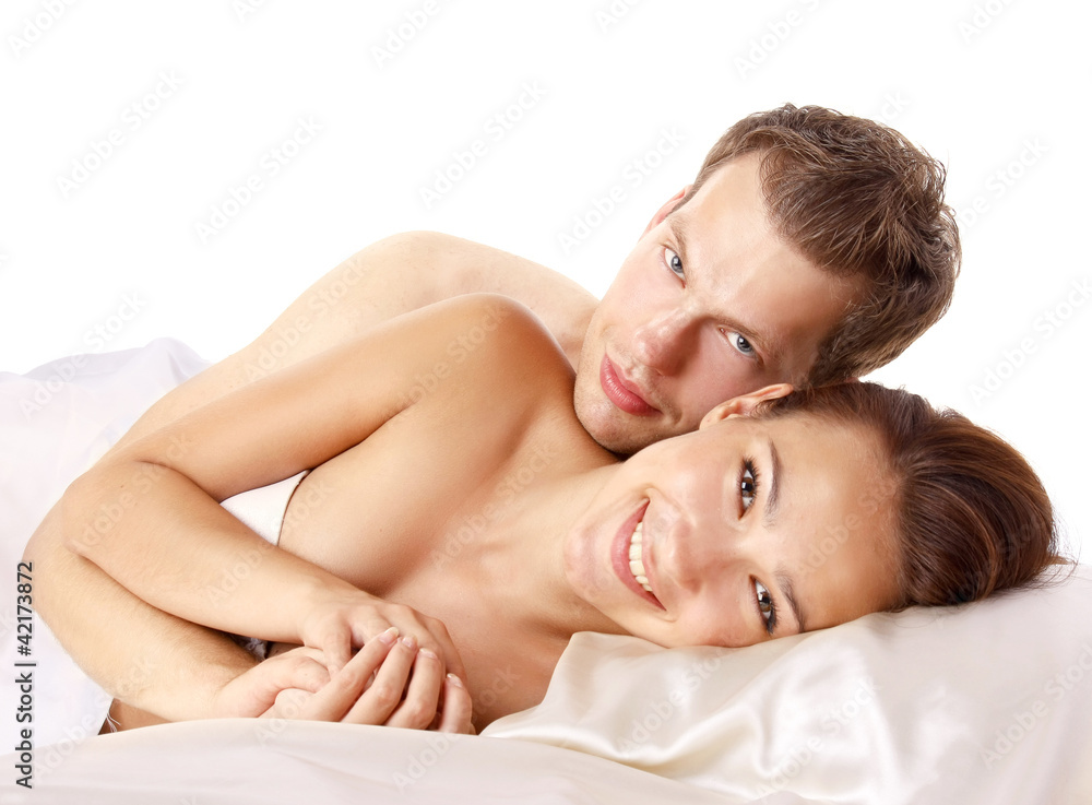 A loving affectionate nude heterosexual couple on the bed A loving affectionate nude heterosexual couple on the bed
