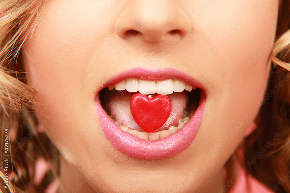 face of beautiful girl smiling and holding a little heart face of beautiful girl smiling and holding a little heart