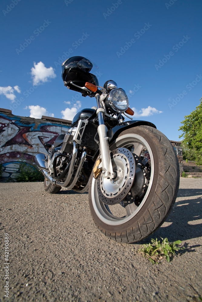 motorcycle on thrown road at wall