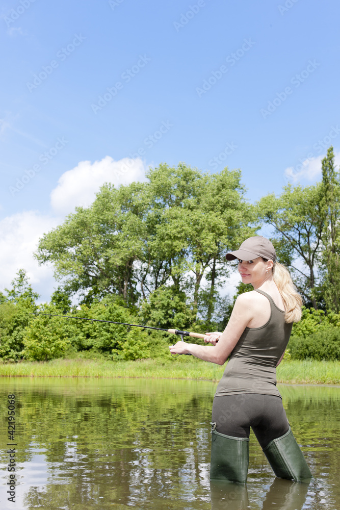 woman fishing in pond woman fishing in pond