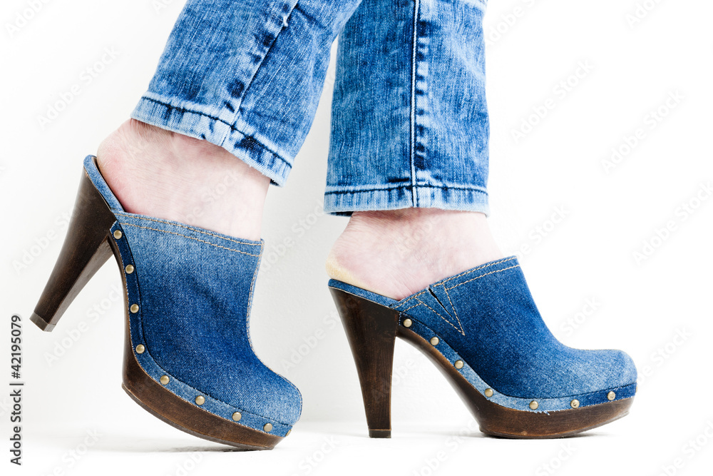 detail of woman wearing denim clogs detail of woman wearing denim clogs