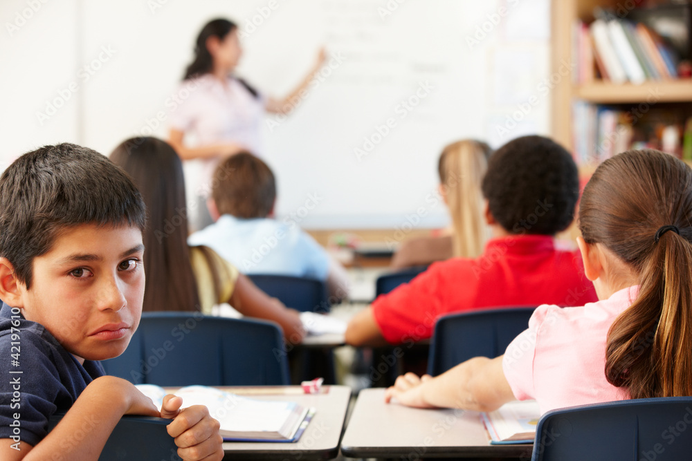 Unhappy schoolboy in class Unhappy schoolboy in class