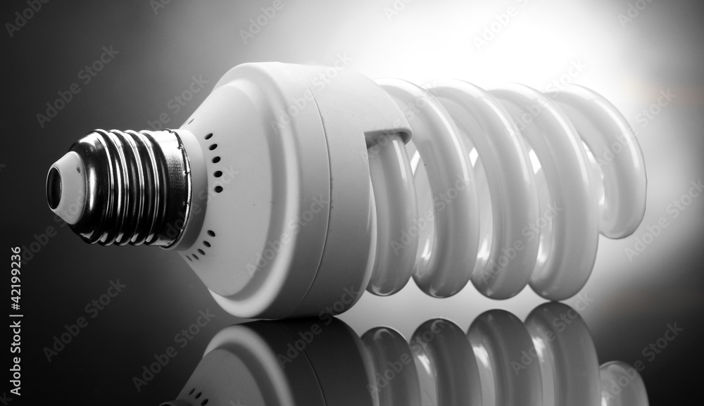 Energy saving lamp on grey background Energy saving lamp on grey background