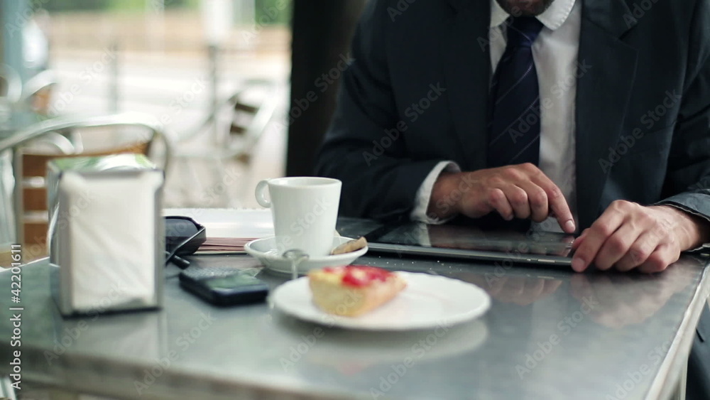 Businessman hands working on tablet computer in cafe Businessman hands working on tablet computer in cafe