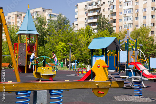 Playground in Bucharest / Children park against communist flats