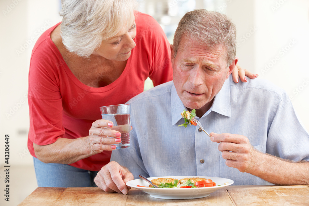 Senior woman looking after sick husband Senior woman looking after sick husband