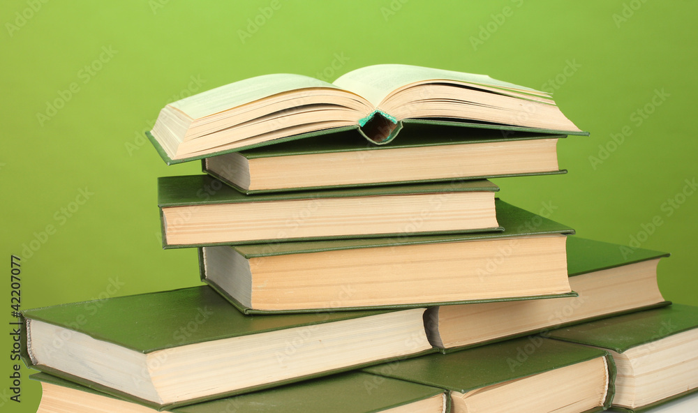 pile of books on green background close-up