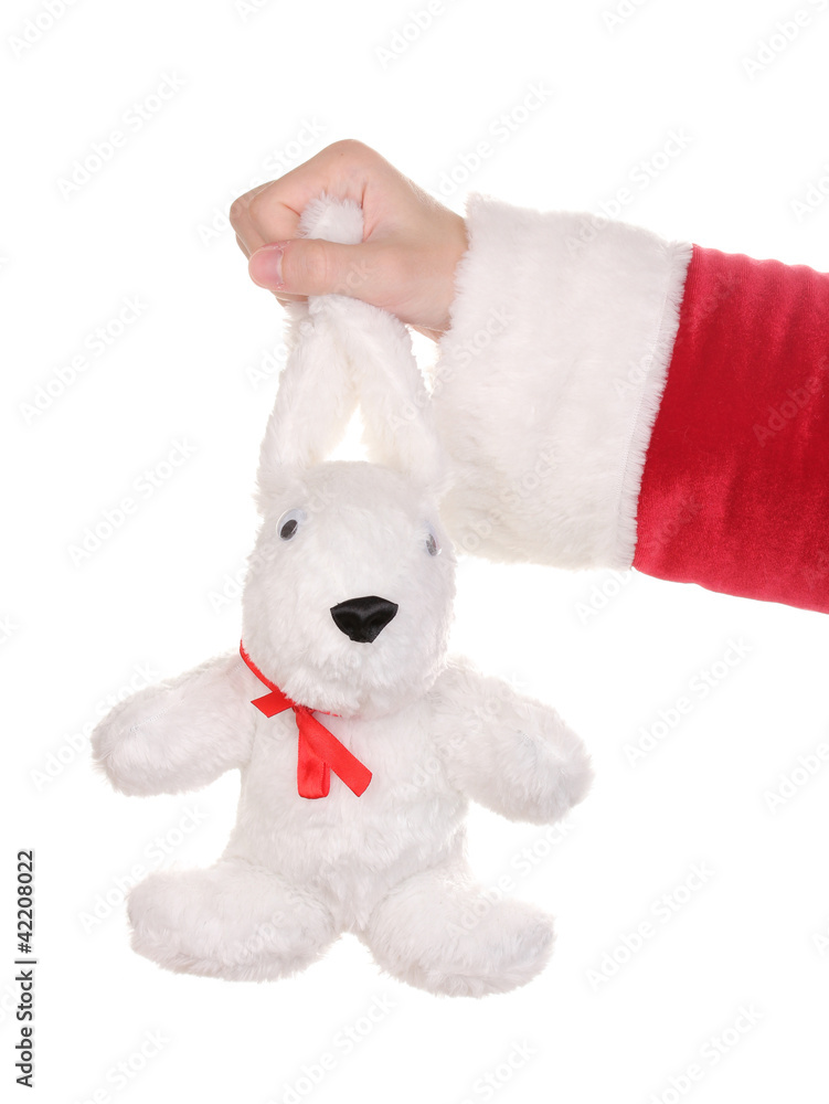 Santa Claus hand holding toy rabbit isolated on white Santa Claus hand holding toy rabbit isolated on white