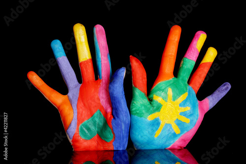 Brightly colored hands on black background