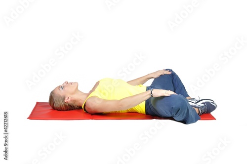 Fit young female yoga instructor on a white background