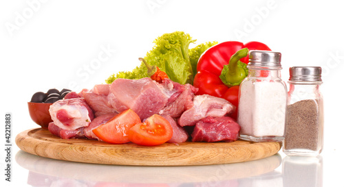 Pieces of raw meat and vegetables