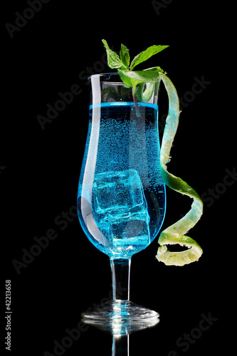 Blue cocktail in glasses on black background