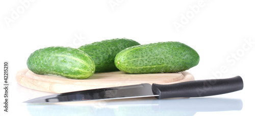 Cucumbers on a cutting board isolated on white