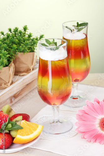 fruit jelly in glasses and fruits on table in cafe