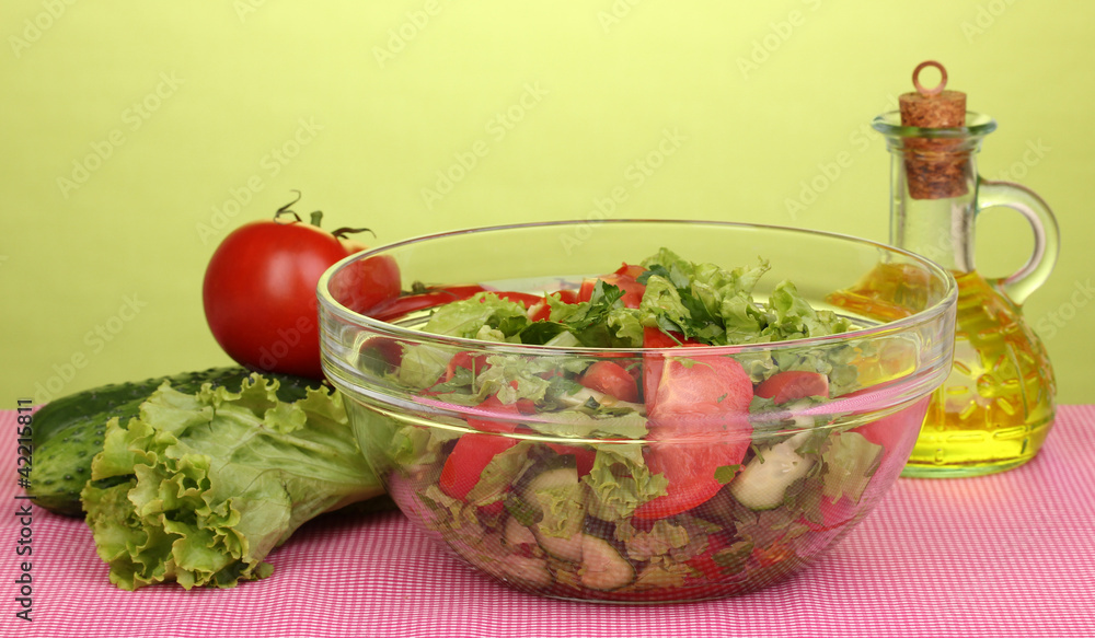 Fresh salad with tomatoes and cucumbers on green background Fresh salad with tomatoes and cucumbers on green background