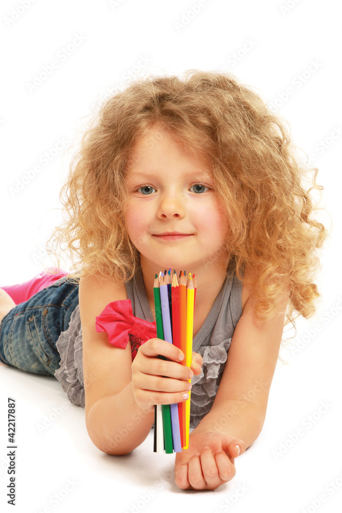 Happy little girl drawing with pencils at home Happy little girl drawing with pencils at home
